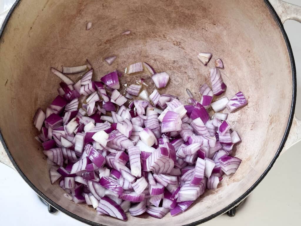 Onions cooking in a Dutch oven.