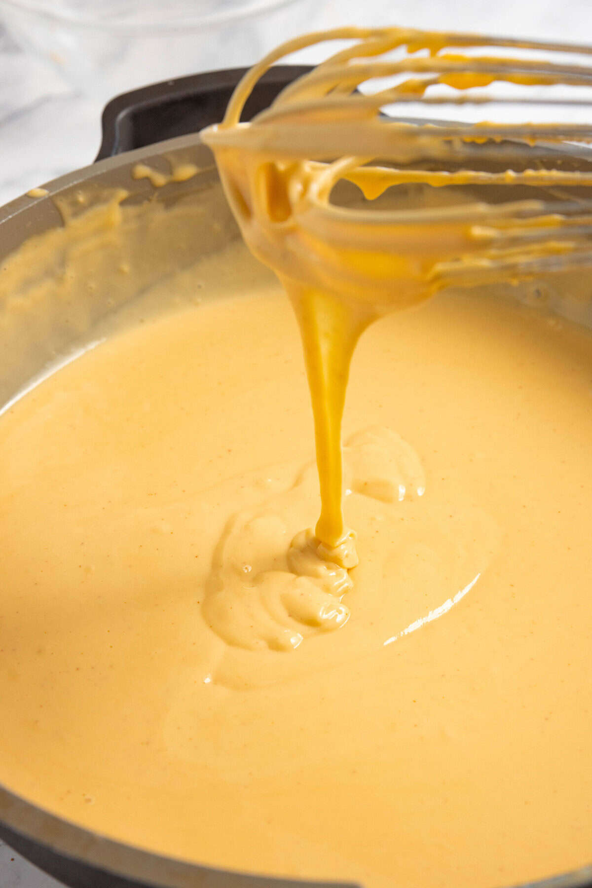 melted cheese sauce in a skillet.