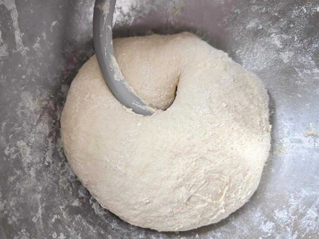 sourdough pretzel dough in the stand mixer with dough hook attachment.