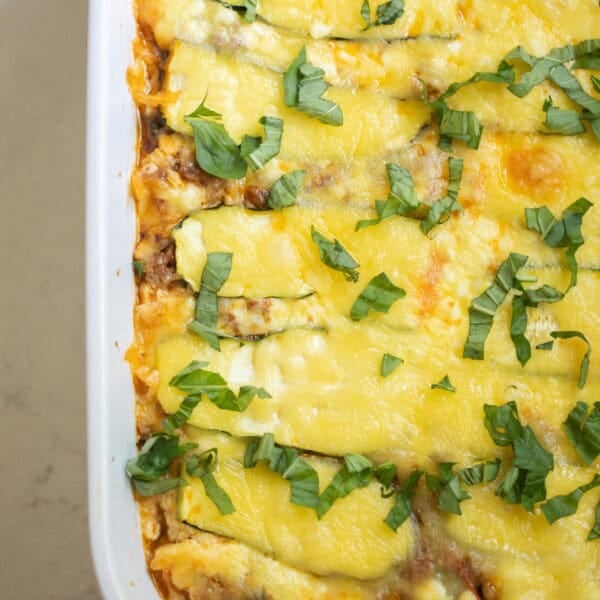 Zucchini lasagna in a white baking dish.