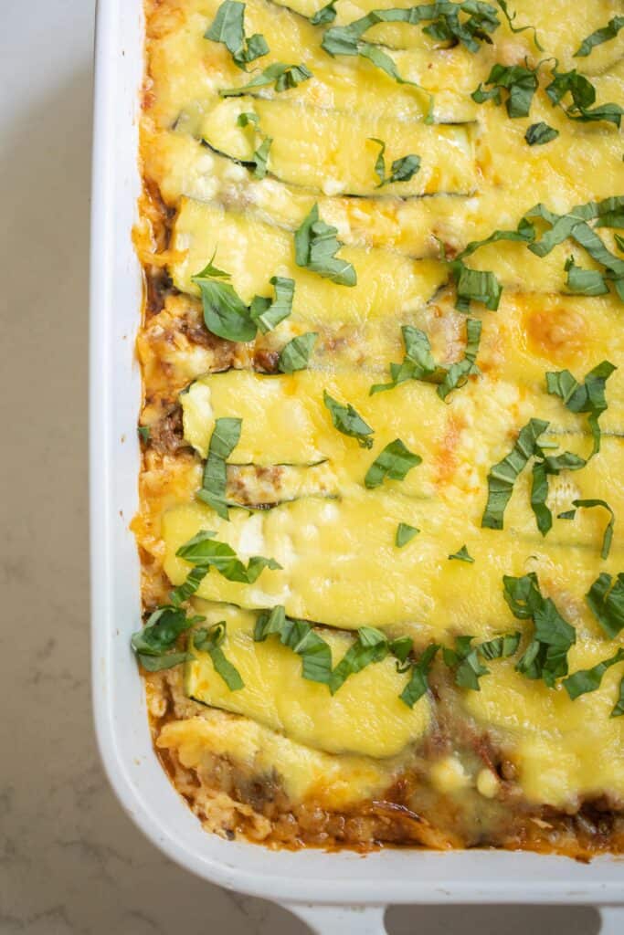 Zucchini lasagna in a white baking dish.