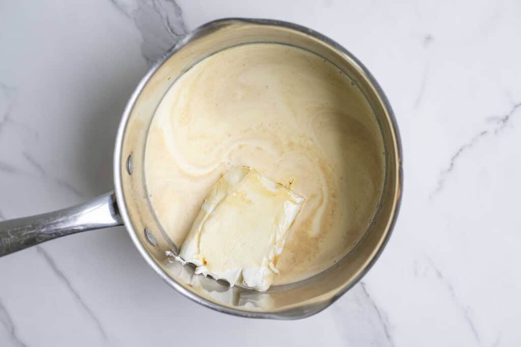 Cream, cream cheese, maple syrup, and vanilla in a saucepan.