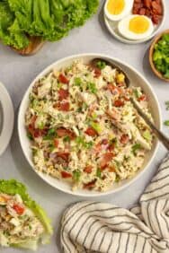 A white bowl full of cobb chicken salad.