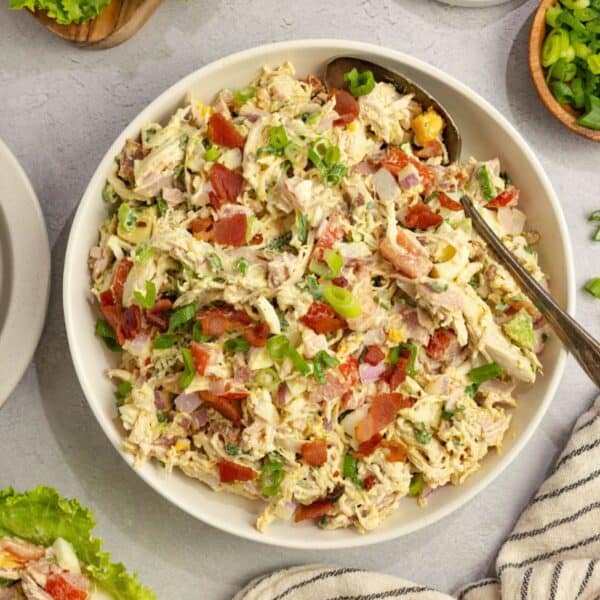 A white bowl full of cobb chicken salad.