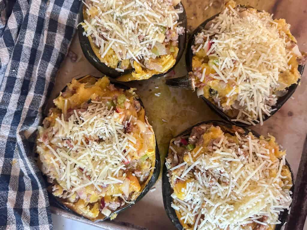 Four halves of acorn squash stuffed and ready for the oven.