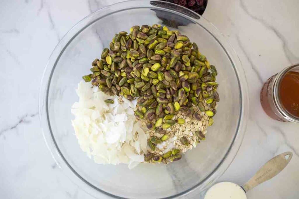 coconut, oats, and nuts in a glass bowl.