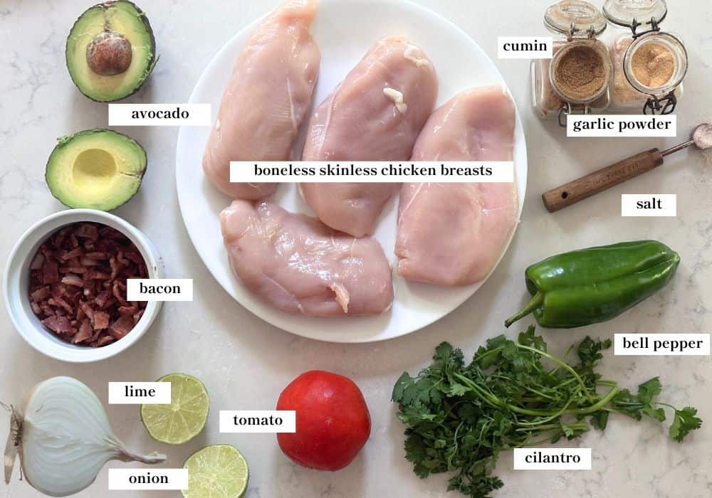 chicken salad ingredients spread out on a white countertop.