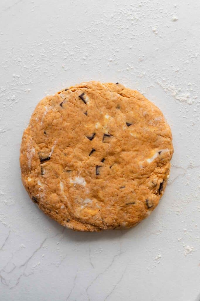 Scone dough patted into a circle ready to be cut.