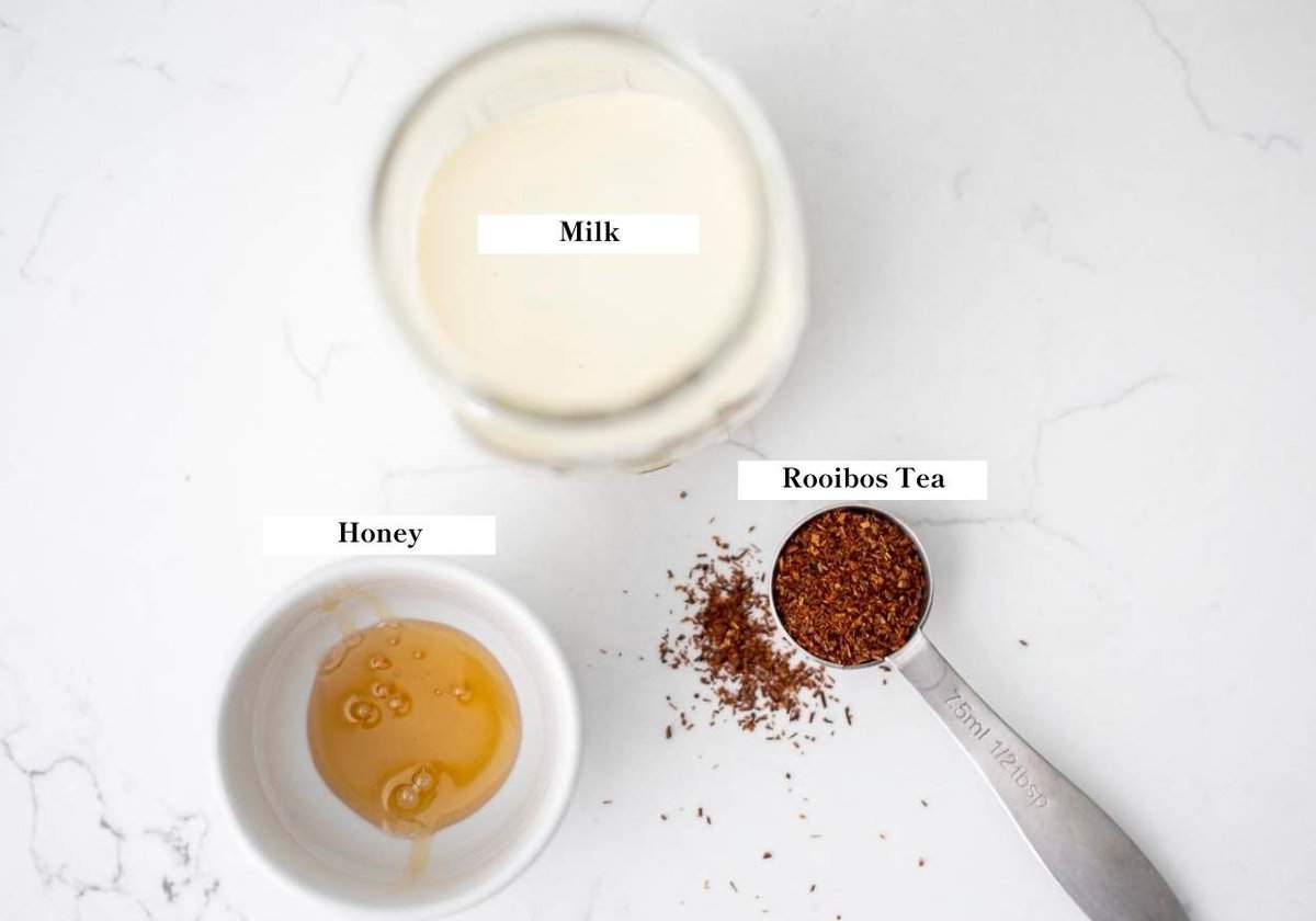 milk, tea, and honey on a countertop.