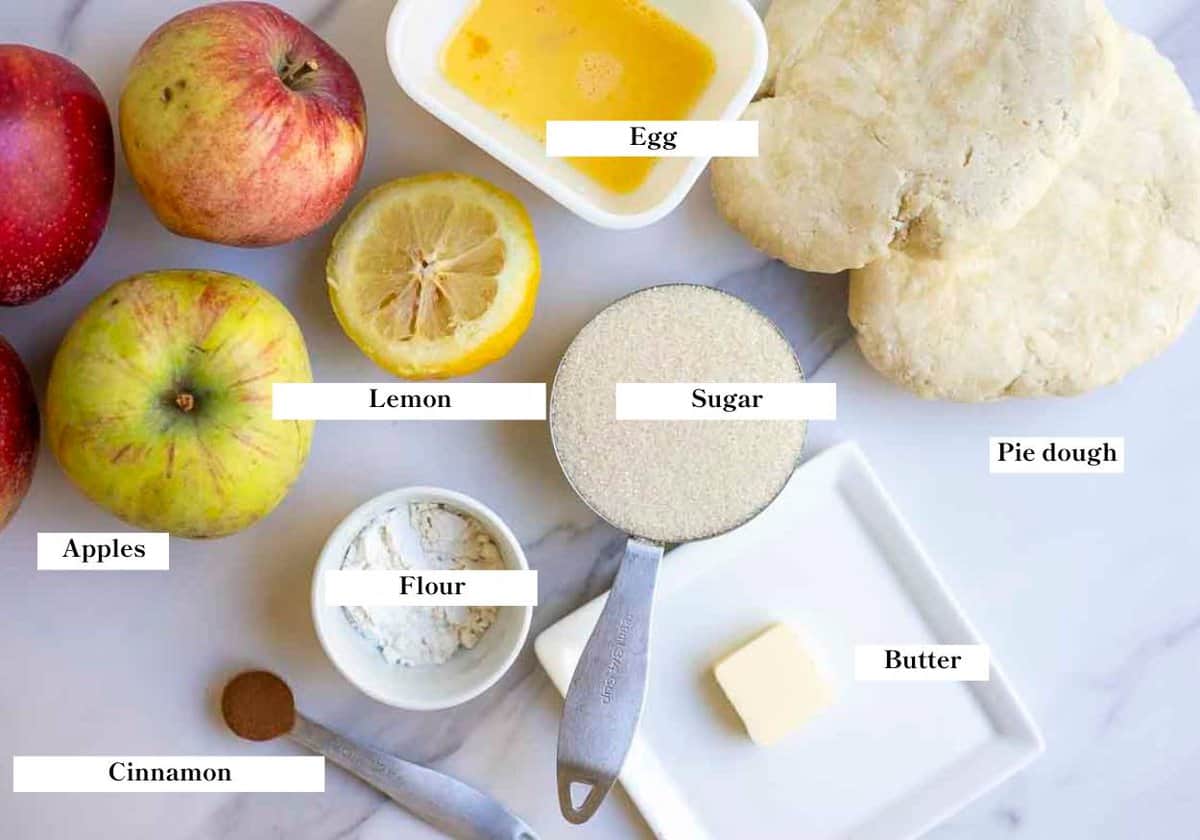 apple pie ingredients spread out on a countertop.