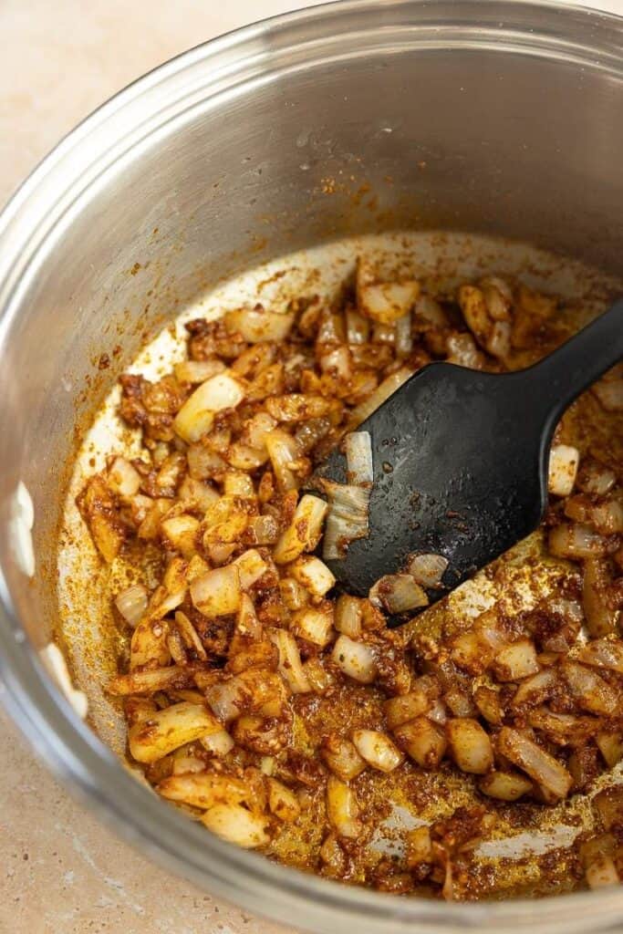 Sauted onions mixed with taco seasoning in a large stock pot. 