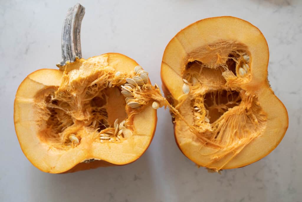 A sugar pumpkin cut in half.