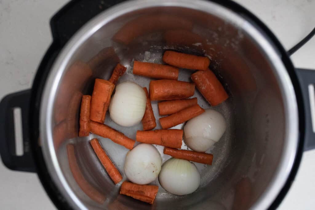 Carrots and onions in an instant pot.