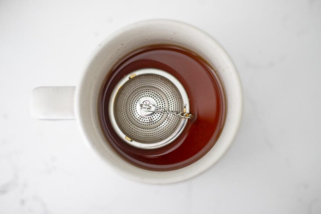 Rooibos tea steeping in a mug.