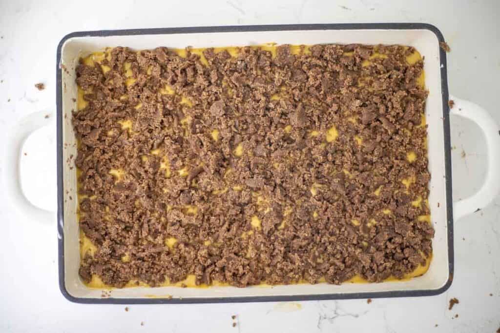 Sourdough pumpkin cobbler topped with a crumble ready for the oven.