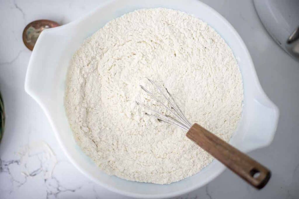 Dry ingredients mixed together with a whisk in a bowl.