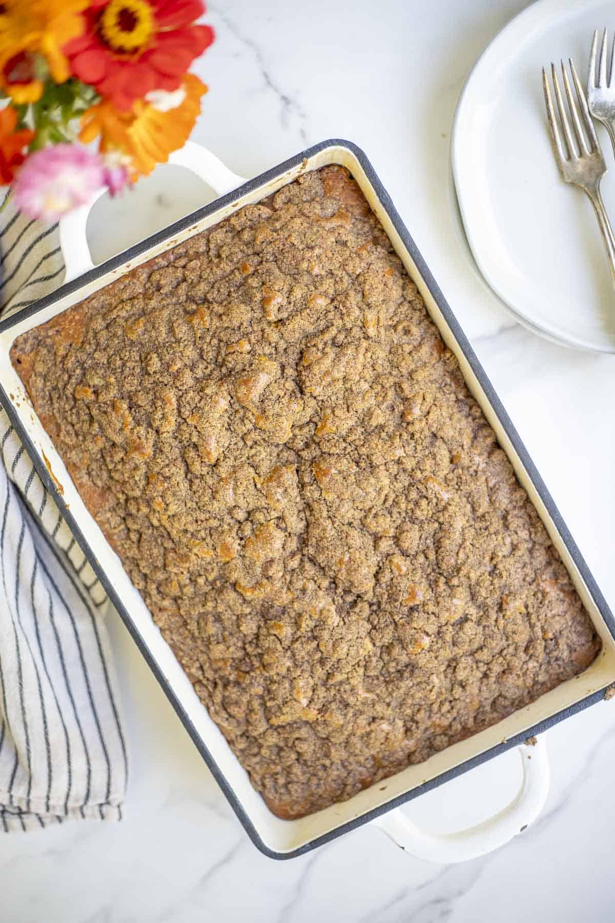 Overhead photo of a sourdough pumpkin coffee cake in a baking dish.