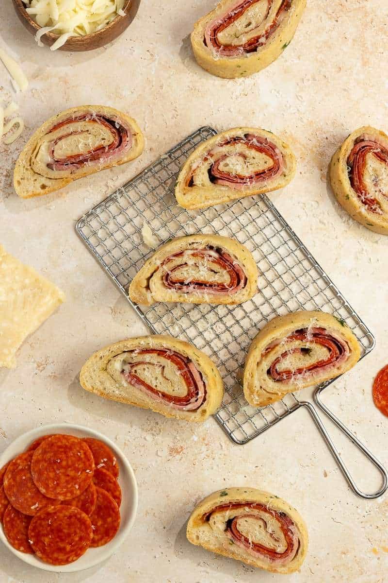 slices of Sourdough Stromboli spread out on a wire rack and countertop.