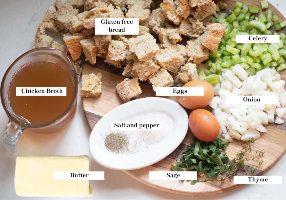 Ingredients for gluten free stuffing spread out on a countertop and cutting board.