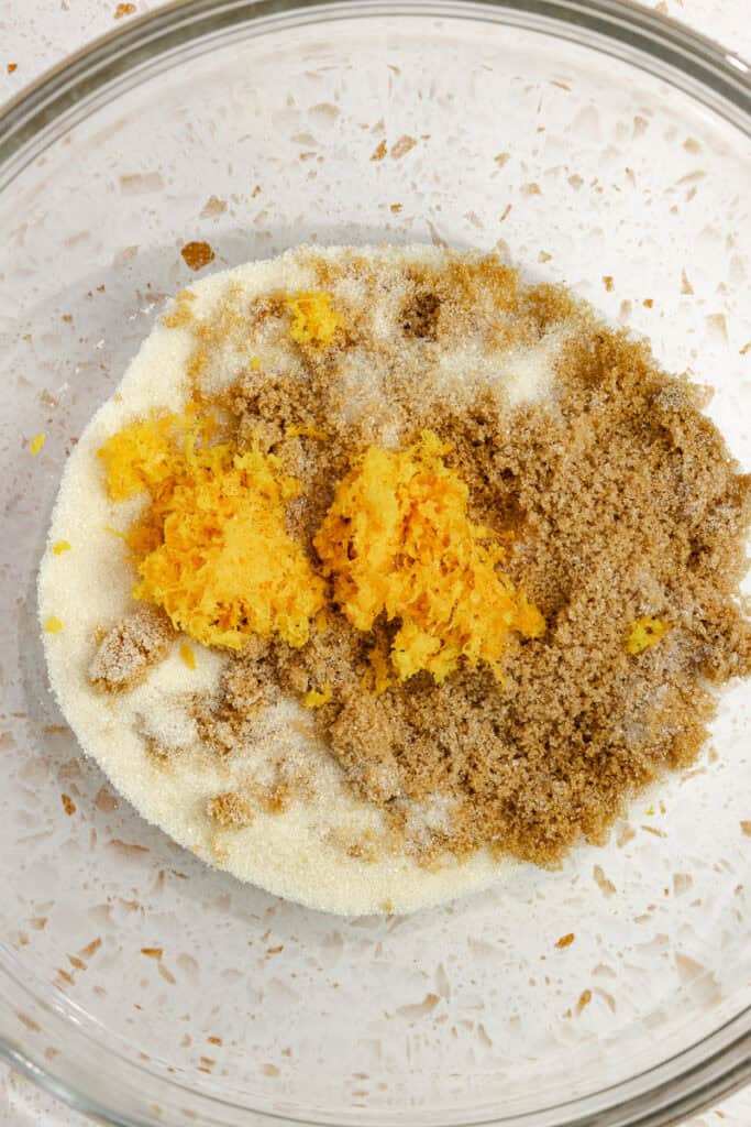 Sugar and orange zest in a bowl.