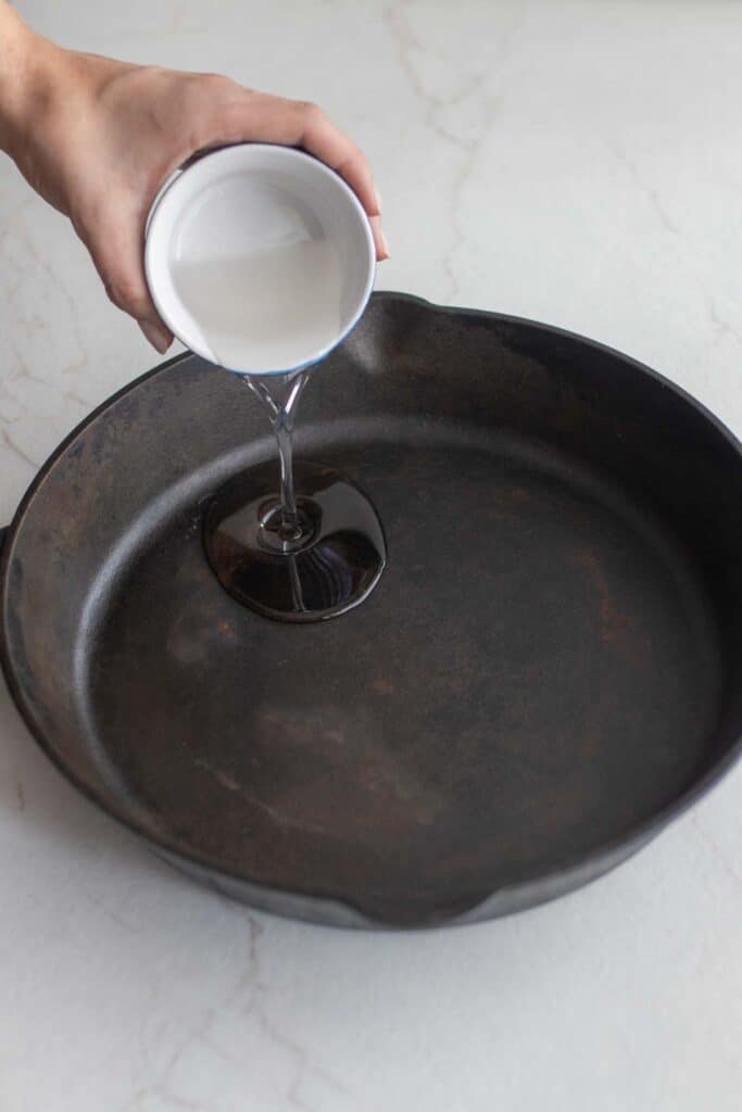 Neutral oil added to a cast iron skillet.