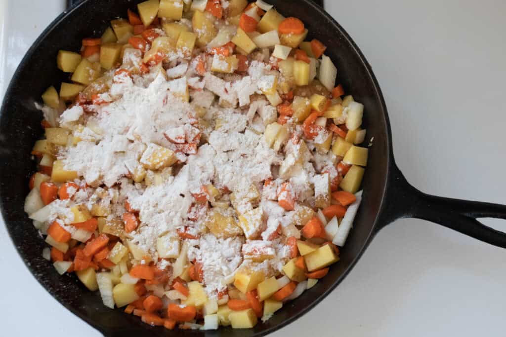 Flour sprinkled on top of sautéed veggies.