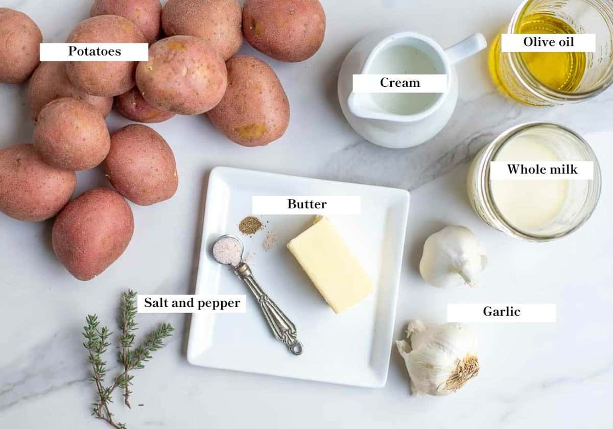 Garlic mashed potatoes ingredients spread onto a countertop.