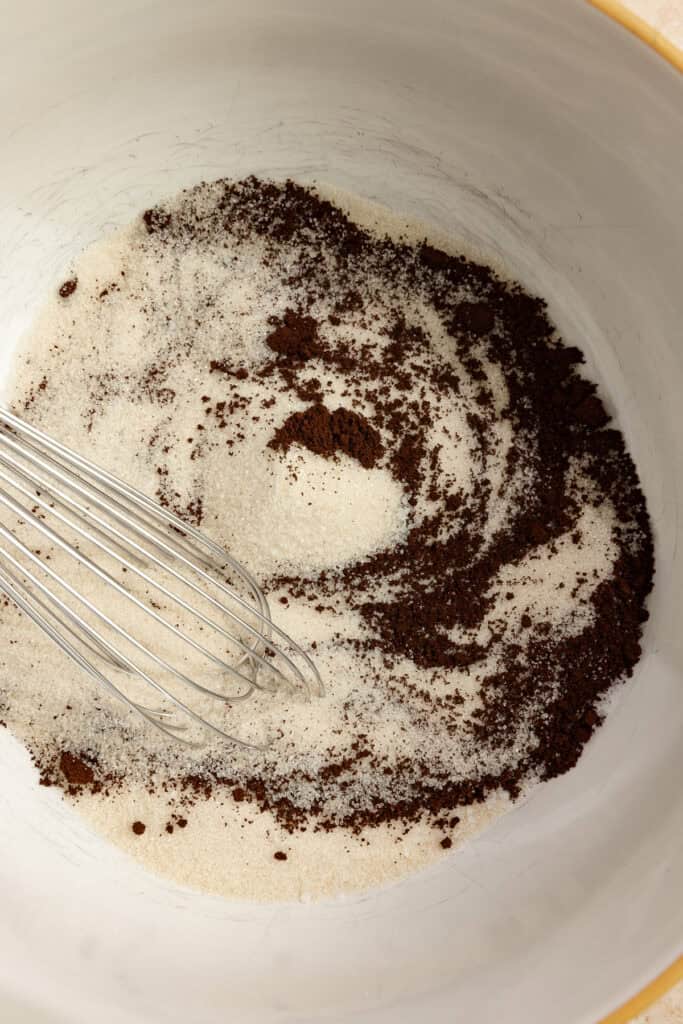 Dry ingredients for chocolate cake whisked together in a bowl.