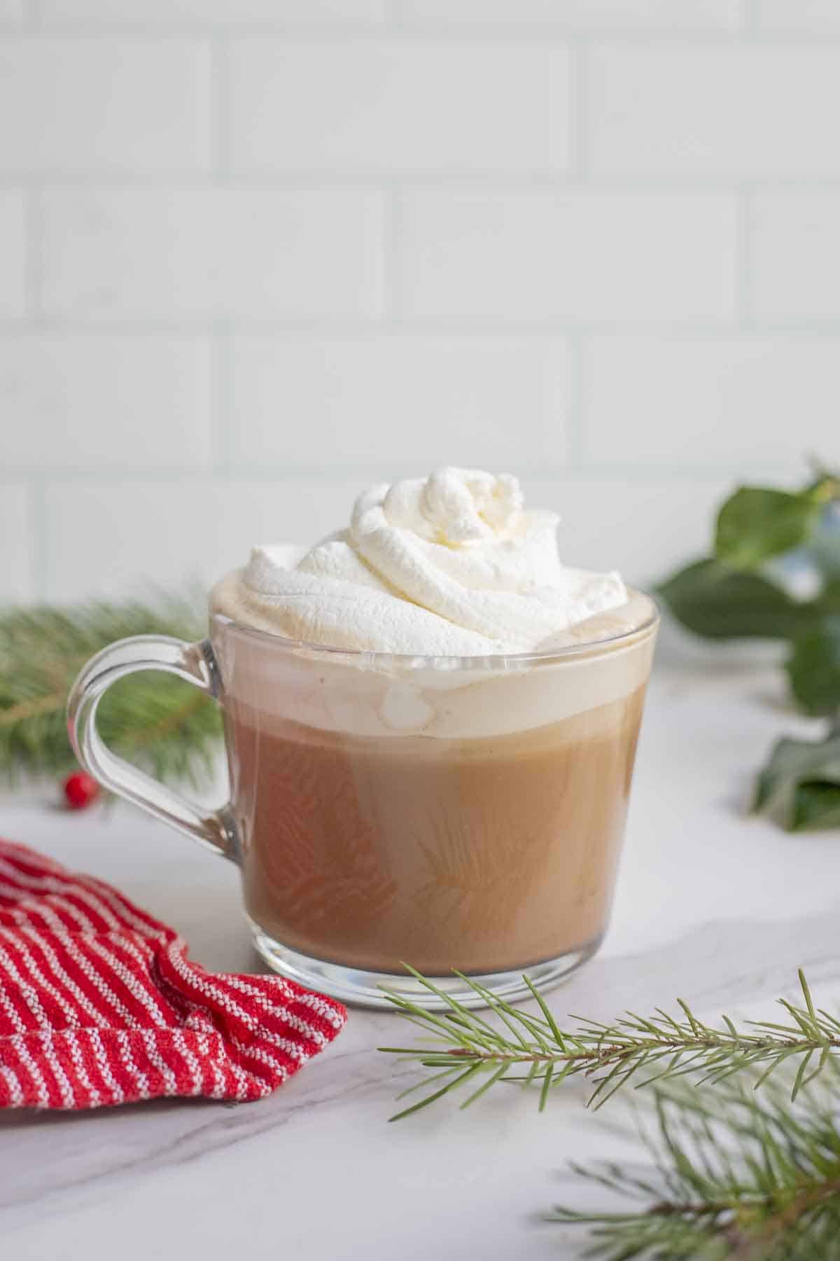 Peppermint mocha poured into a much and topped with fresh whipped cream.