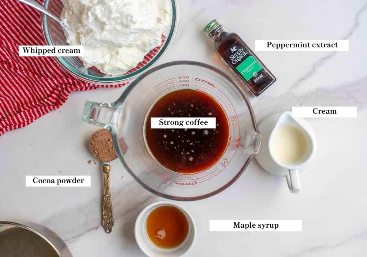 Coffee, cream, maple syrup and other ingredients on a countertop.