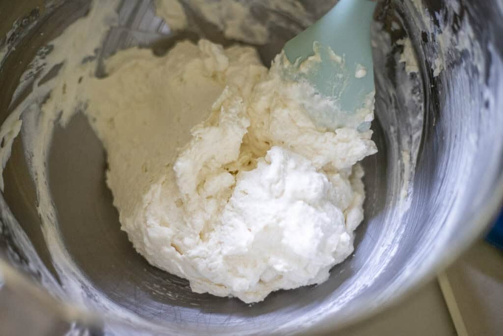 Crepe filling being mixed in a bowl with a spatula.