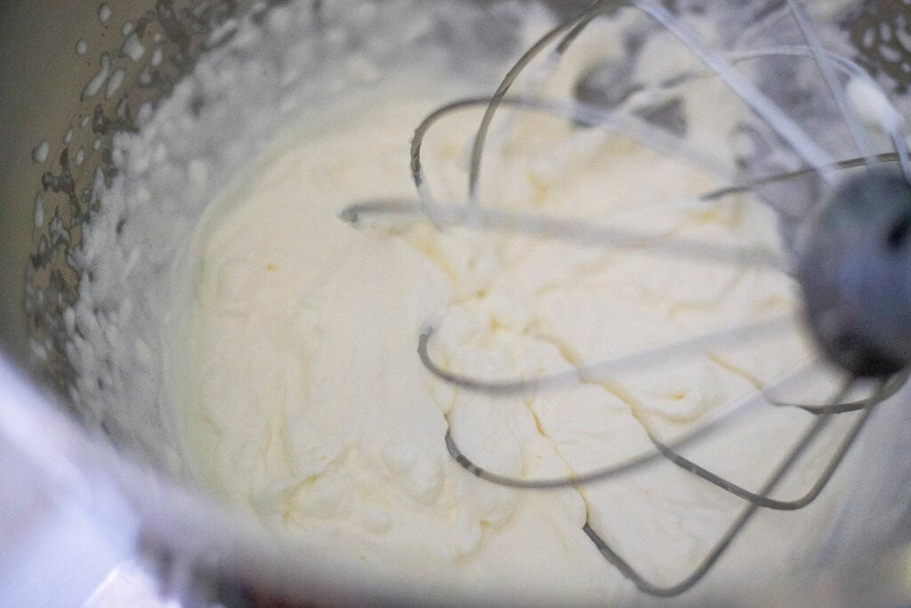 Crepe filling in a stand mixer with a whisk attachment. 