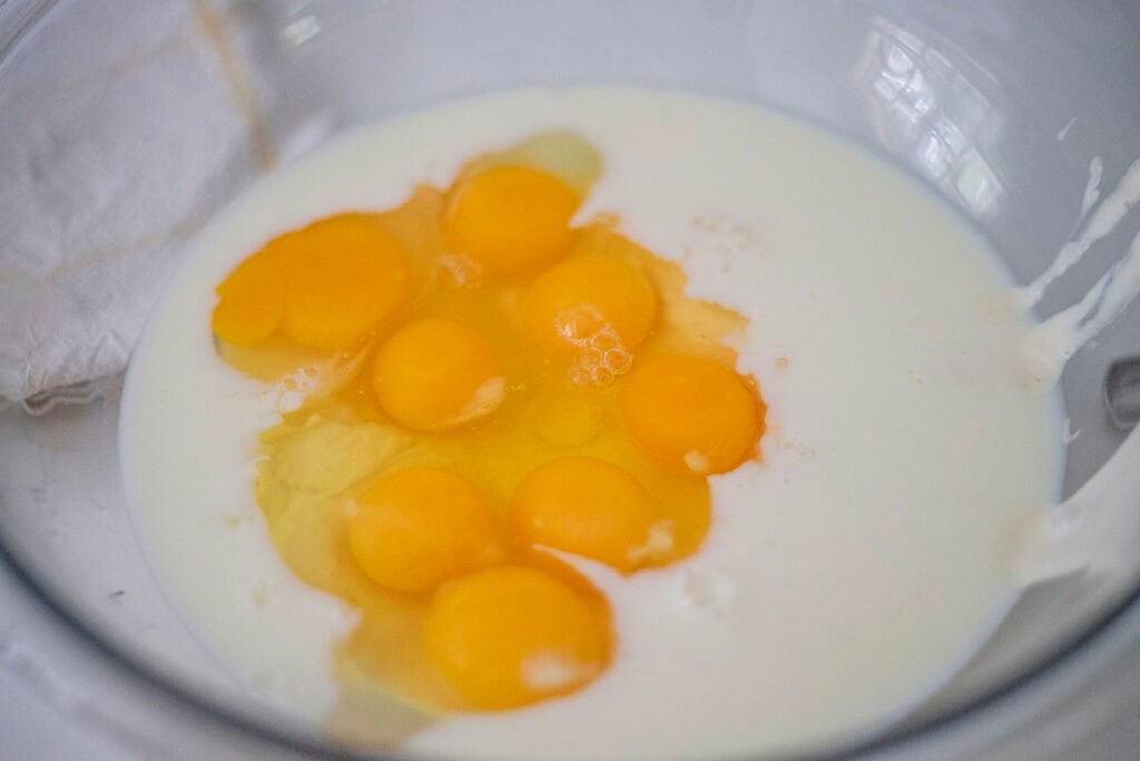 Eggs cracked into a bowl of milk.