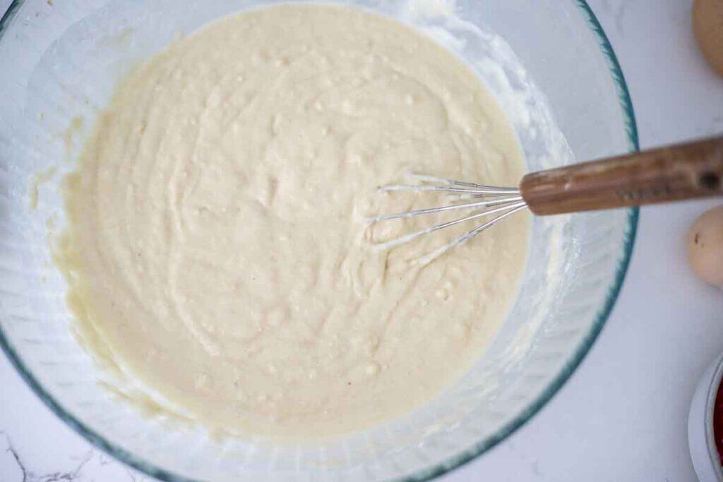 Sourdough discard pancake batter mixed together in a bowl with a whisk.