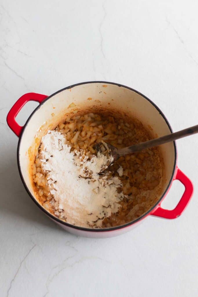 Flour added to onions in a Dutch oven. 