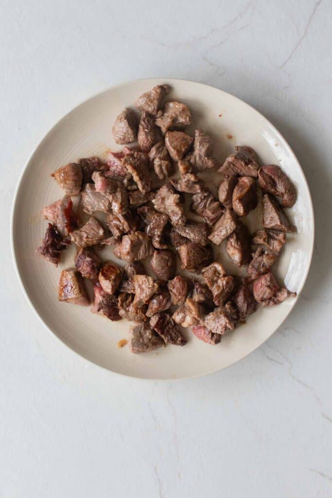 A plate of cooked stew meat. 