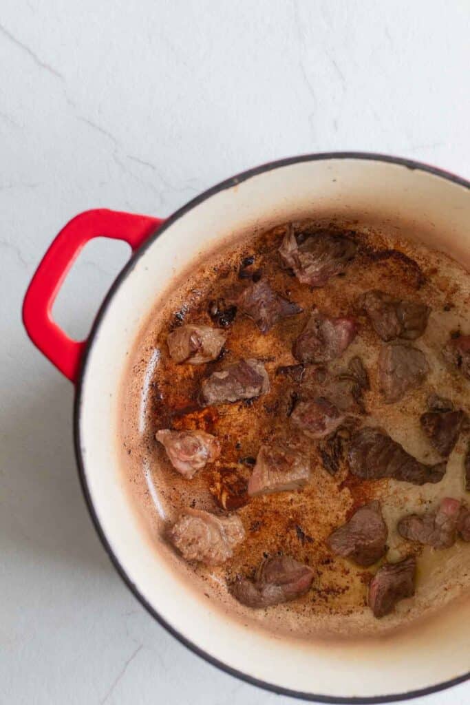 Beef browning in a Dutch oven. 