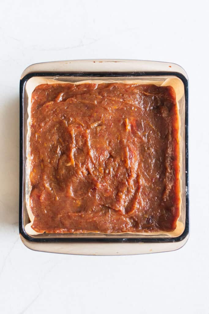 The middle layer added on top of the crust in a square baking pan.