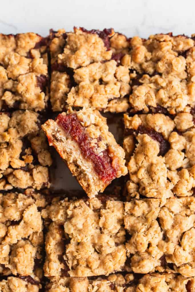 A pan of date squares cut with one popping out. 