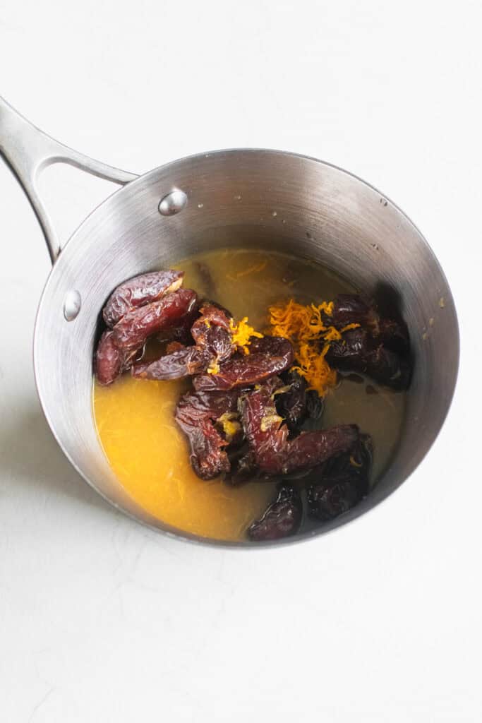 Dates and orange juice in a sauce pan.