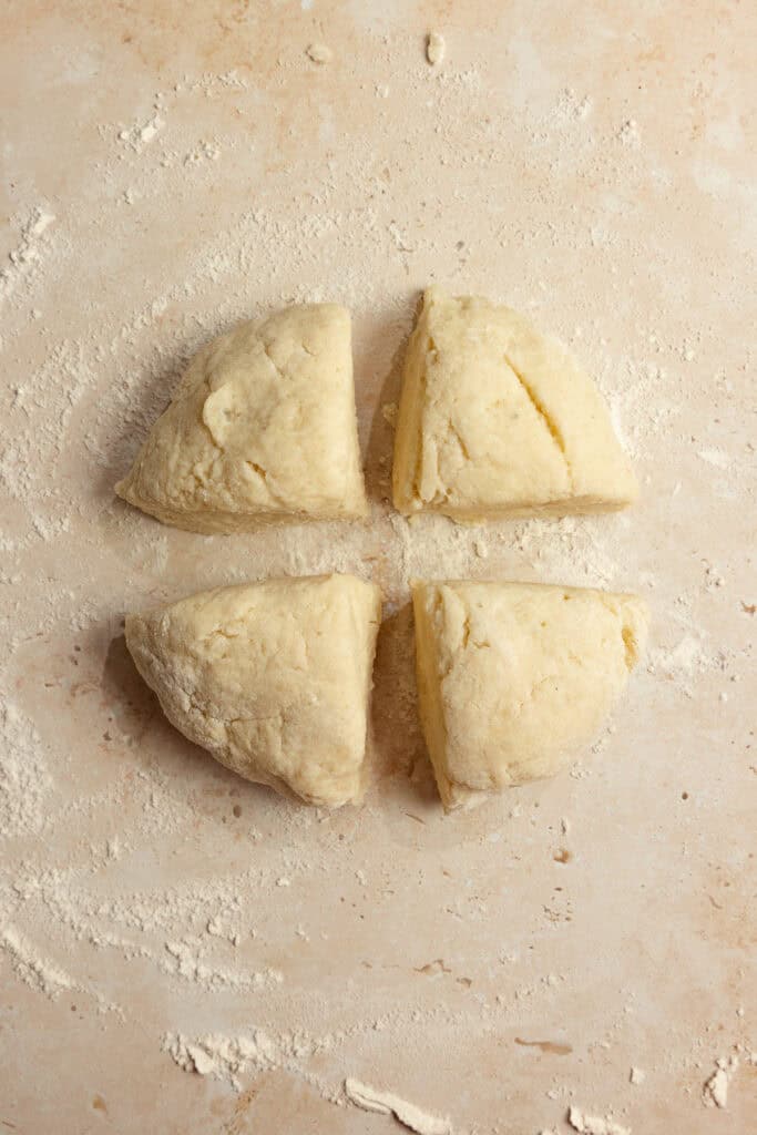 A dough ball cut into four sections. 