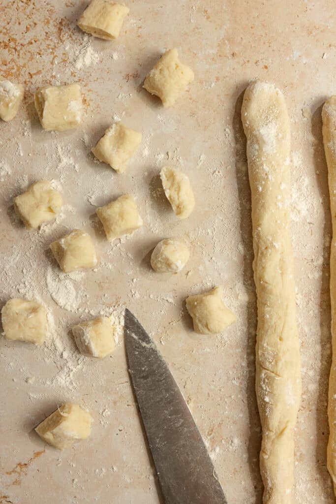 Ropes of dough cut into 1 inch pieces.