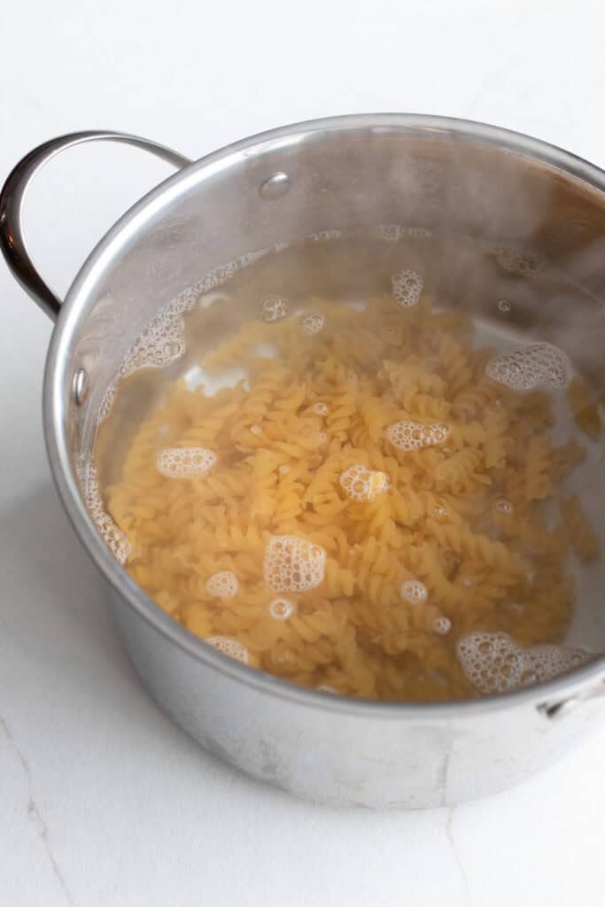 A large pot of water with pasta boiling.