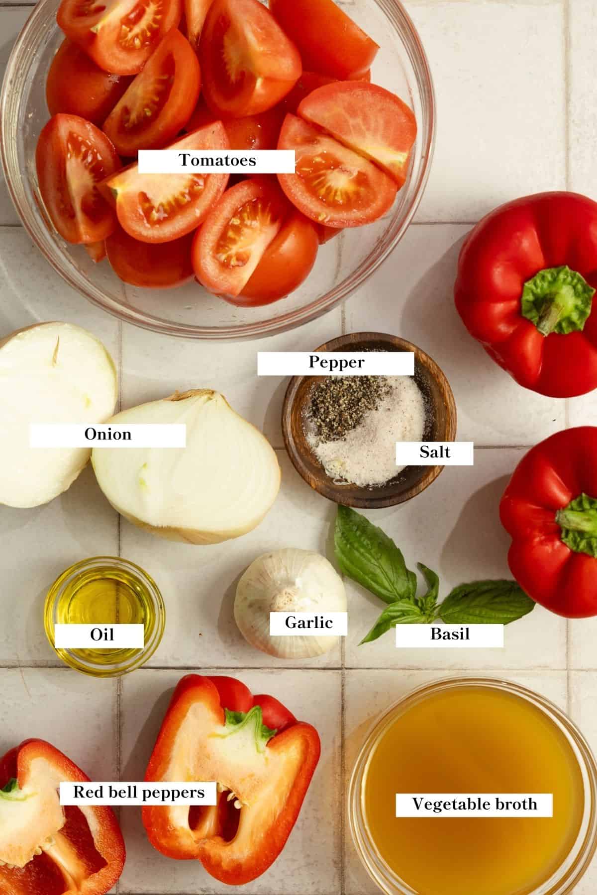 Ingredients for roasted red pepper and tomato soup laid out on the counter top.