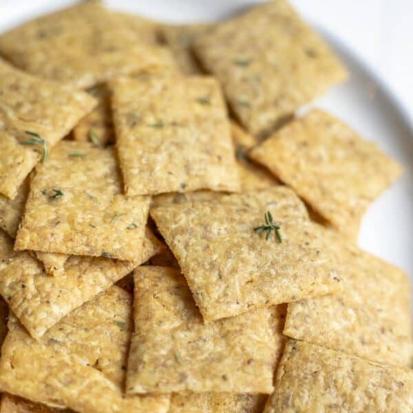 A plate of sourdough crackers topped with fresh thyme.