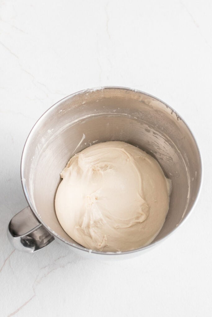 Dough in the bowl of a stand mixer.