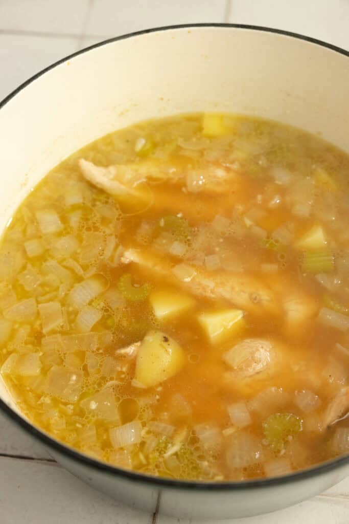 Broth added to veggies in a Dutch oven. 