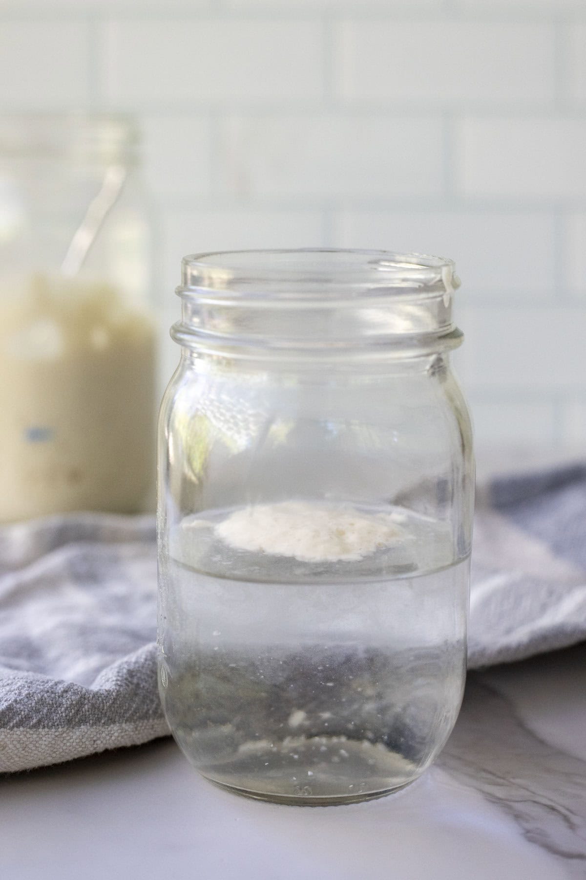 Sourdough starter floating on top of water to preform the "float test".