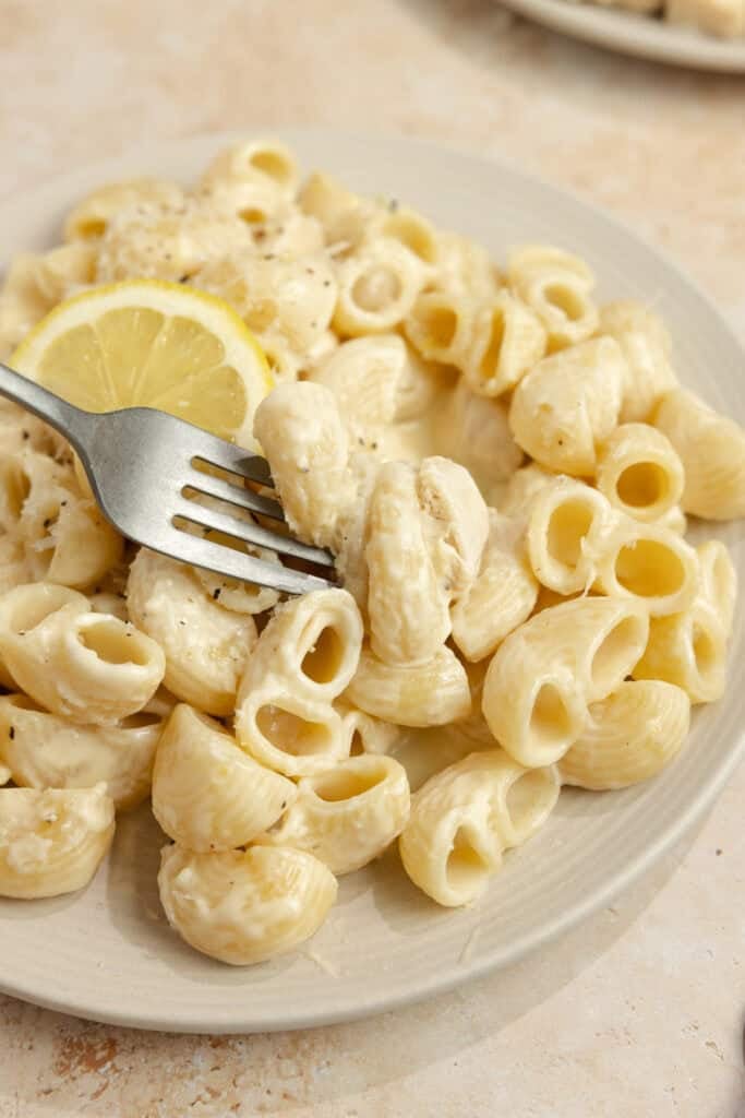 Pasta in a serving dish with a fork. 